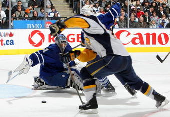 TORONTO - APRIL 8:  Adam Mair #22 of the Buffalo Sabres missed on this scoring opportunity as Curtis Joseph #31 of the Toronto Maple Leafs dives across the crease during their NHL game at the Air Canada Centre April 8, 2009 in Toronto, Ontario.(Photo By Dave Sandford/Getty Images)