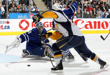 TORONTO - APRIL 8:  Adam Mair #22 of the Buffalo Sabres missed on this scoring opportunity as Curtis Joseph #31 of the Toronto Maple Leafs dives across the crease during their NHL game at the Air Canada Centre April 8, 2009 in Toronto, Ontario.(Photo By Dave Sandford/Getty Images)