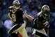 PHILADELPHIA - SEPTEMBER 20:  Drew Brees #9 hands off to Mike Bell #21 of the New Orleans Saints during a game against the Philadelphia Eagles at Lincoln Financial Field on September 20, 2009 in Philadelphia, Pennsylvania.  (Photo by Jeff Zelevansky/Getty Images)