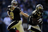 PHILADELPHIA - SEPTEMBER 20:  Drew Brees #9 hands off to Mike Bell #21 of the New Orleans Saints during a game against the Philadelphia Eagles at Lincoln Financial Field on September 20, 2009 in Philadelphia, Pennsylvania.  (Photo by Jeff Zelevansky/Getty Images)