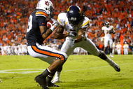 AUBURN, AL - SEPTEMBER 19: Darvin Adams #89 of the Auburn Tigers scores a touchdown as he gets tackled by Robert Sands #2 of the West Virginia Mountaineers at Jordan-Hare Stadium on September 19, 2009 in Auburn, Alabama. (Photo by Kevin C. Cox/Getty Images)