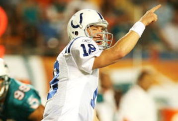 MIAMI - SEPTEMBER 21:  Quarterback Peyton Manning #18 of the Indianapolis Colts points out to his wide receiver against the Miami Dolphins at Land Shark Stadium on September 21, 2009 in Miami, Florida. The Colts defeated the Dolphins 27-23.  (Photo by Doug Benc/Getty Images)