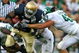 SOUTH BEND, IN - SEPTEMBER 19: Armando Allen #5 of the Notre Dame Fighting Irish is tackled by Greg Jones #53, Trevor Anderson #58 and Eric Gordon #43 of the Michigan State Spartans on September 19, 2009 at Notre Dame Stadium in South Bend, Indiana. Notre Dame defeated Michigan State 33-30. (Photo by Jonathan Daniel/Getty Images)