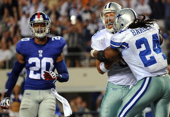 ARLINGTON, TX - SEPTEMBER 20:  Quarterback Tony Romo #9 celebrates his touchdown run with Marion Barber #24 of the Dallas Cowboys in front of Michael Johnson #20 of the New York Giants at Cowboys Stadium on September 20, 2009 in Arlington, Texas.  (Photo by Ronald Martinez/Getty Images)