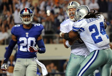 ARLINGTON, TX - SEPTEMBER 20:  Quarterback Tony Romo #9 celebrates his touchdown run with Marion Barber #24 of the Dallas Cowboys in front of Michael Johnson #20 of the New York Giants at Cowboys Stadium on September 20, 2009 in Arlington, Texas.  (Photo by Ronald Martinez/Getty Images)