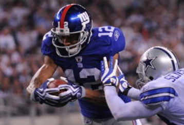 ARLINGTON, TX - SEPTEMBER 20:  Wide receiver Steve Smith #12 of the New York Giants dives for a touchdown against Gerald Sensabaugh #43 of the Dallas Cowboys at Cowboys Stadium on September 20, 2009 in Arlington, Texas.  (Photo by Ronald Martinez/Getty Images)