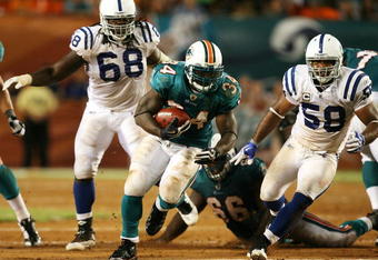MIAMI - SEPTEMBER 21: Running back Ricky Williams #34 of the Miami Dolphins looks for room to run after getting past linebacker Gary Brackett #58 of the Indianapolis Colts at Land Shark Stadium on September 21, 2009 in Miami, Florida. The Colts defeated the Dolphins 27-23.  (Photo by Doug Benc/Getty Images)