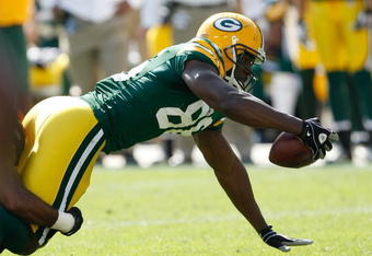 GREEN BAY, WI - SEPTEMBER 20: Tight end Jermichael Finley #88 of the Green Bay Packers reaches for additional yardage after a pass reception against the Cincinnati Bengals at Lambeau Field on September 20, 2009 in Green Bay, Wisconsin. The Bengals defeated the Packers 31-24. (Photo by Scott Boehm/Getty Images)