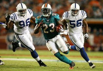 MIAMI - SEPTEMBER 21:  Running back Ronnie Brown #23 of the Miami Dolphins runs away from defensive end Keyunta Dawson #96 and lienbacker Tyjuan Hagler #56 of the Indianapolis Colts at Land Shark Stadium on September 21, 2009 in Miami, Florida.  (Photo by Doug Benc/Getty Images)