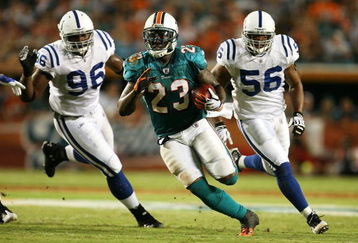 MIAMI - SEPTEMBER 21:  Running back Ronnie Brown #23 of the Miami Dolphins runs away from defensive end Keyunta Dawson #96 and lienbacker Tyjuan Hagler #56 of the Indianapolis Colts at Land Shark Stadium on September 21, 2009 in Miami, Florida.  (Photo by Doug Benc/Getty Images)