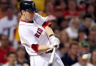 BOSTON - JULY 06:  Jason Bay #44 of the Boston Red Sox gets a hit against the Oakland Athletics on July 6, 2009 at Fenway Park in Boston, Massachusetts. The Athletics defeated the Red Sox 6-0. (Photo by Elsa/Getty Images)