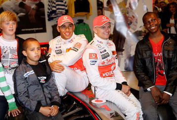 LONDON, ENGLAND - SEPTEMBER 17:  Formula 1 drivers Lewis Hamilton (L) and Heikki Kovalainen pose for a photograph as they launch their Grand Prix-themed boyswear range 'Living the Dream' produced exclusively by M&S with Vodafone McLaren Mercedes at Marks and Spencer Marble Arch on September 17, 2009 in London, England.  (Photo by Chris Jackson/Getty Images)