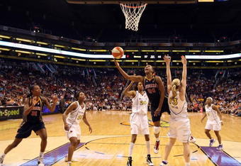 PHOENIX - AUGUST 08:  Tamika Catchings #24 of the Indiana Fever lays up a shot past Penny Taylor #13 of the Phoenix Mercury during the WNBA game at US Airways Center on August 8, 2009 in Phoenix, Arizona. NOTE TO USER: User expressly acknowledges and agrees that, by downloading and or using this photograph, User is consenting to the terms and conditions of the Getty Images License Agreement.  (Photo by Christian Petersen/Getty Images)