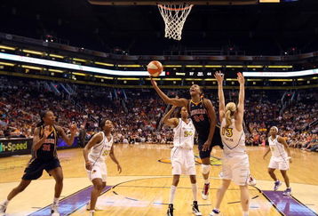 PHOENIX - AUGUST 08:  Tamika Catchings #24 of the Indiana Fever lays up a shot past Penny Taylor #13 of the Phoenix Mercury during the WNBA game at US Airways Center on August 8, 2009 in Phoenix, Arizona. NOTE TO USER: User expressly acknowledges and agrees that, by downloading and or using this photograph, User is consenting to the terms and conditions of the Getty Images License Agreement.  (Photo by Christian Petersen/Getty Images)