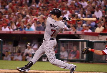 ANAHEIM, CA - JULY 24:  Joe Mauer #7 of the Minnesota Twins hits his second home run of the game in the sixth inning against the Los Angeles Angels of Anaheim on July 24, 2009 at Angel Stadium in Anaheim, California.  (Photo by Stephen Dunn/Getty Images)