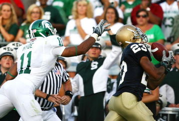 SOUTH BEND, IN - SETPEMBER 19: Golden Tate #23 of the Notre Dame Fighting Irish catches the game- winning touchdown pass over Marcus Hyde #11 of the Michigan State Spartans on September 19, 2009 at Notre Dame Stadium in South Bend, Indiana. Notre Dame defeated Michigan State 33-30. (Photo by Jonathan Daniel/Getty Images)