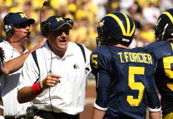 ANN ARBOR, MI - SEPTEMBER 19:  Head coach Rich Rodriguez of the Michigan Wolverines talks with quarterback Tate Forcier #5 during the game with the Eastern Michigan Eagles at Michigan Stadium on September 19, 2009 in Ann Arbor, Michigan.  (Photo by Stephen Dunn/Getty Images)