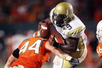 FORT LAUDERDALE, FL - SEPTEMBER 17:  Quarterback Josh Nesbitt #9 of the Georgia Tech Yellow Jackets is brought down by linebacker Colin McCarthy #44 of the Miami Hurricanes at Land Shark Stadium on September 17, 2009 in Fort Lauderdale, Florida. Miami defeated Georgia Tech 33-17.  (Photo by Doug Benc/Getty Images)