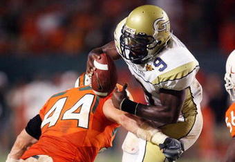 FORT LAUDERDALE, FL - SEPTEMBER 17:  Quarterback Josh Nesbitt #9 of the Georgia Tech Yellow Jackets is brought down by linebacker Colin McCarthy #44 of the Miami Hurricanes at Land Shark Stadium on September 17, 2009 in Fort Lauderdale, Florida. Miami defeated Georgia Tech 33-17.  (Photo by Doug Benc/Getty Images)