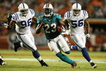 MIAMI - SEPTEMBER 21:  Running back Ronnie Brown #23 of the Miami Dolphins runs away from defensive end Keyunta Dawson #96 and lienbacker Tyjuan Hagler #56 of the Indianapolis Colts at Land Shark Stadium on September 21, 2009 in Miami, Florida.  (Photo by Doug Benc/Getty Images)