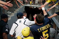 ANN ARBOR, MI - SEPTEMBER 12:  Quarterback Tate Forcier #5 and Michigan head coach Rich Rodriguez give high-fives as they leave the field after beating Notre Dame 38-34 at Michigan Stadium on September 12, 2009 in Ann Arbor, Michigan.  (Photo by Domenic Centofanti/Getty Images)