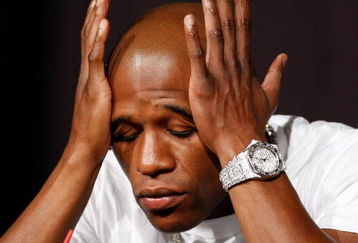 LAS VEGAS - SEPTEMBER 16:  Boxer Floyd Mayweather Jr. rubs his face during the final news conference for his bout against Juan Manuel Marquez at the MGM Grand Hotel/Casino September 16, 2009 in Las Vegas, Nevada. The two will fight at the MGM Grand Garden Arena on September 19 in Las Vegas.  (Photo by Ethan Miller/Getty Images)