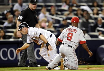 NEW YORK - SEPTEMBER 14:  Brett Gardner  #11 of the New York Yankees gets to his feet to run to home in front of Chone Figgins #9 of the Los Angeles Angels of Anaheim in the eighth inning of a game at Yankee Stadium on September 14, 2009 in the Bronx borough of New York City.  (Photo by Jeff Zelevansky/Getty Images)