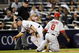 NEW YORK - SEPTEMBER 14:  Brett Gardner  #11 of the New York Yankees gets to his feet to run to home in front of Chone Figgins #9 of the Los Angeles Angels of Anaheim in the eighth inning of a game at Yankee Stadium on September 14, 2009 in the Bronx borough of New York City.  (Photo by Jeff Zelevansky/Getty Images)