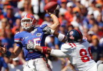 GAINESVILLE, FL - SEPTEMBER 27:  Quarterback Tim Tebow #15 of the Florida Gators is pressured by Greg Hardy #86 of the Ole Miss Rebels during the game at Ben Hill Griffin Stadium on September 27, 2008 in Gainesville, Florida.  (Photo by Sam Greenwood/Getty Images)