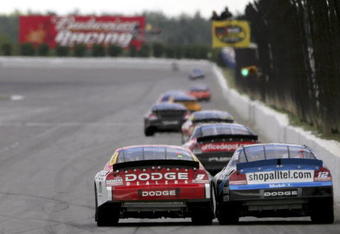 LONG POND, PA - JUNE 11:  Kasey Kahne, driver of the #9 Dodge Dealers/UAW Dodge, and Ryan Newman, driver of the #12 Alltel Dodge, rub fenders as they head down the home straight during the NASCAR Nextel Cup Series Pocono 500 at the Pocono Raceway on June 11, 2006 in Long Pond, Pennsylvania.  (Photo by Doug Pensinger/Getty Images)