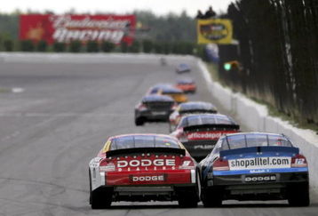 LONG POND, PA - JUNE 11:  Kasey Kahne, driver of the #9 Dodge Dealers/UAW Dodge, and Ryan Newman, driver of the #12 Alltel Dodge, rub fenders as they head down the home straight during the NASCAR Nextel Cup Series Pocono 500 at the Pocono Raceway on June 11, 2006 in Long Pond, Pennsylvania.  (Photo by Doug Pensinger/Getty Images)