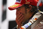 SINGAPORE - SEPTEMBER 28:  Fernando Alonso of Spain and Renault celebrates on the podium after winning the Singapore Formula One Grand Prix at the Marina Bay Street Circuit on September 28, 2008 in Singapore.  The event is the first Formula One race to be held at night.  (Photo by Clive Mason/Getty Images)