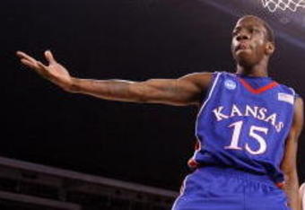 INDIANAPOLIS - MARCH 27:  Tyshawn Taylor #15 of the Kansas Jayhawks reacts after he dunked the ball against the Michigan State Spartans during the third round of the NCAA Division I Men's Basketball Tournament at the Lucas Oil Stadium on March 27, 2009 in Indianapolis, Indiana.  (Photo by Andy Lyons/Getty Images)