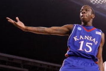 INDIANAPOLIS - MARCH 27:  Tyshawn Taylor #15 of the Kansas Jayhawks reacts after he dunked the ball against the Michigan State Spartans during the third round of the NCAA Division I Men's Basketball Tournament at the Lucas Oil Stadium on March 27, 2009 in Indianapolis, Indiana.  (Photo by Andy Lyons/Getty Images)