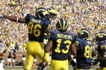 ANN ARBOR, MI - SEPTEMBER 05: Kevin Koger #86 of the Michigan Wolverines celebrates a second quarter touchdown catch with Greg Mathews #13, Martell Webb #80 and Carlos Brown #23 while playing the Western Michigan Broncos on September 5, 2009 at Michigan Stadium in Ann Arbor, Michigan.  (Photo by Gregory Shamus/Getty Images)