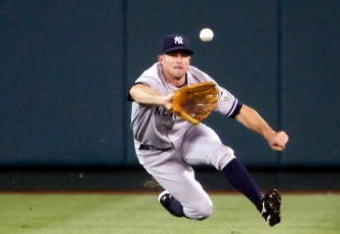 ANAHEIM, CA - SEPTEMBER 22:  Center fielder Brett Gardner #11 of the New York Yankees dives to make a catch on a ball hit by Chone Figgins of the Los Angeles Angels of Anaheim in the first inning at Angel Stadium on September 22, 2009 in Anaheim, California.  (Photo by Jeff Gross/Getty Images)