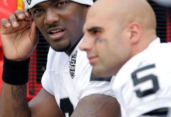 KANSAS CITY, MO - SEPTEMBER 20:  Quarterback JaMarcus Russell #2 of the Oakland Raiders talks with Bruce Gradkowski #5 on the bench during the game against the Kansas City Chiefs at Arrowhead Stadium on September 20, 2009 in Kansas City, Missouri.  (Photo by Jamie Squire/Getty Images)