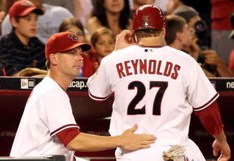 PHOENIX - JULY 23:  Manager A.J. Hinch of the Arizona Diamondbacks congratulates Mark Reynolds after scoring against the Pittsburgh Pirates during the major league baseball game at Chase Field on July 23, 2009 in Phoenix, Arizona. The Diamondbacks defeated the Pirates 11-4.  (Photo by Christian Petersen/Getty Images)