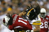 TAMPA, FL - FEBRUARY 01:  Larry Fitzgerald #11 of the Arizona Cardinals gets tackled by Troy Polamalu #43 of the Pittsburgh Steelers in the fourth quarter during Super Bowl XLIII on February 1, 2009 at Raymond James Stadium in Tampa, Florida.  (Photo by Al Bello/Getty Images)