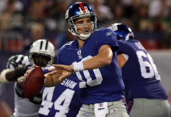 EAST RUTHERFORD, NJ - AUGUST 29:  Eli Manning #10 of the New York Giants looks to throw a pass against the New York Jets on August 29, 2009 at Giants Stadium in East Rutherford, New Jersey.  (Photo by Jim McIsaac/Getty Images)
