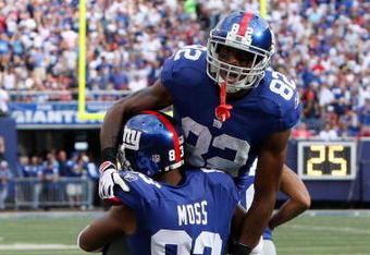EAST RUTHERFORD, NJ - SEPTEMBER 13:  Mario Manningham #82 of the New York Giants celebrates his second quarter touchdown against the Washington Redskins with teammate Sinorice Moss #83 on September 13, 2009 at Giants Stadium in East Rutherford, New Jersey.  (Photo by Jim McIsaac/Getty Images)