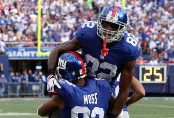 EAST RUTHERFORD, NJ - SEPTEMBER 13:  Mario Manningham #82 of the New York Giants celebrates his second quarter touchdown against the Washington Redskins with teammate Sinorice Moss #83 on September 13, 2009 at Giants Stadium in East Rutherford, New Jersey.  (Photo by Jim McIsaac/Getty Images)