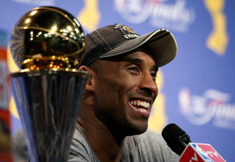 ORLANDO, FL - JUNE 14:  Kobe Bryant #24 of the Los Angeles Lakers smiles during the post game news conference after the Lakers defeated the Orlando Magic 99-86 to win the NBA Championship in Game Five of the 2009 NBA Finals on June 14, 2009 at Amway Arena in Orlando, Florida.  NOTE TO USER:  User expressly acknowledges and agrees that, by downloading and or using this photograph, User is consenting to the terms and conditions of the Getty Images License Agreement.  (Photo by Elsa/Getty Images)