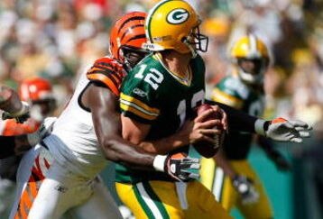 GREEN BAY, WI - SEPTEMBER 20: Quarterback Aaron Rogers #12 of the Green Bay Packers is sacked by defensive end Antwan Odem #98 of the Cincinnati Bengals at Lambeau Field on September 20, 2009 in Green Bay, Wisconsin. The Bengals defeated the Packers 31-24. (Photo by Scott Boehm/Getty Images)