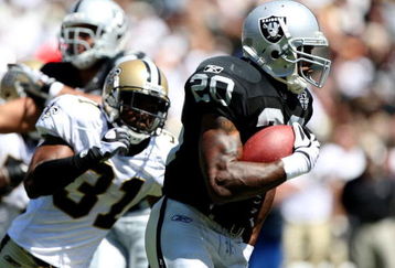 OAKLAND, CA - AUGUST 29:  Running back Darren McFadden #20 of the Oakland Raiders runs the ball against Pierson Prioleau #31 of the New Orleans Saints during the preseason game at Oakland-Alameda County Coliseum on August 29, 2009 in Oakland, California. (Photo by Jed Jacobsohn/Getty Images)