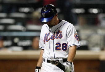 NEW YORK - SEPTEMBER 23:  Daniel Murphy #28 of the New York Mets walks to the dugout after striking out against the Atlanta Braves during the game on September 23, 2009 at Citi Field in the Flushing neighborhood of the Queens borough of New York City.  (Photo by Jared Wickerham/Getty Images)