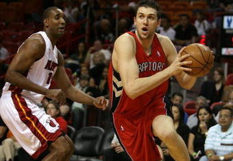 MIAMI - MARCH 05:  Andrea Bargnani #7 of the Toronto Raptors drives past Mark Blount #15 of the Miami Heat at American Airlines Arena on March 5,  2008 in Miami, Florida.  NOTE TO USER: User expressly acknowledges and agrees that, by downloading and or using this photograph, User is consenting to the terms and conditions of the Getty Images License Agreement.  (Photo by Doug Benc/Getty Images)