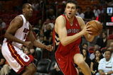 MIAMI - MARCH 05:  Andrea Bargnani #7 of the Toronto Raptors drives past Mark Blount #15 of the Miami Heat at American Airlines Arena on March 5,  2008 in Miami, Florida.  NOTE TO USER: User expressly acknowledges and agrees that, by downloading and or using this photograph, User is consenting to the terms and conditions of the Getty Images License Agreement.  (Photo by Doug Benc/Getty Images)