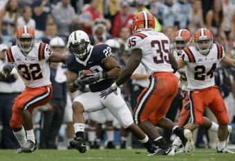 STATE COLLEGE, PA - SEPTEMBER 12: Tail back Evan Royster #22 of the Penn State Nittany Lions rushes through linebacker Doug Hogue #32 and safety Mike Holmes #35 of the Syracuse Orangemen during the first half at Beaver Stadium  September 12, 2009 in State College, Pennsylvania. (Photo by Chris Gardner/Getty Images)