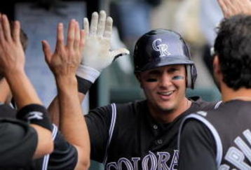 DENVER - JULY 12:  Troy Tulowitzki #2 of the Colorado Rockies is welcomed back to the dugout after his fourth inning solo homerun against the Atlanta Braves during MLB action at Coors Field on July 12, 2009 in Denver, Colorado.  (Photo by Doug Pensinger/Getty Images)